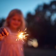 Shot of an unrecognizable little girl playing with a sparkler at night time outside in nature
