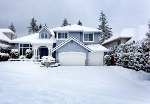 Snow storm in United States with residential home and dark sky in background