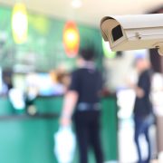 Security camera on blurred background of people in the cafe, concept of security and safety, protect your business