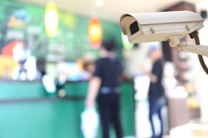 Security camera on blurred background of people in the cafe, concept of security and safety