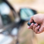Image of someone using a car remote / keyless entry to unlock a car