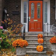 A front door to a house with Halloween decorations, a reminder of Halloween home security