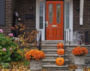 A front door to a house with Halloween decorations, a reminder of Halloween home security