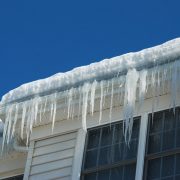 Ice dams in gutter, suggesting the importance of winter home preparation