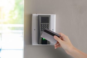 An image of an employee using an access control system, which can help reduce internal theft