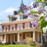 An image of a house during spring, part of a post on home security travel tips for spring break