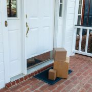 Delivered packages at a door, part of a blog post on package theft